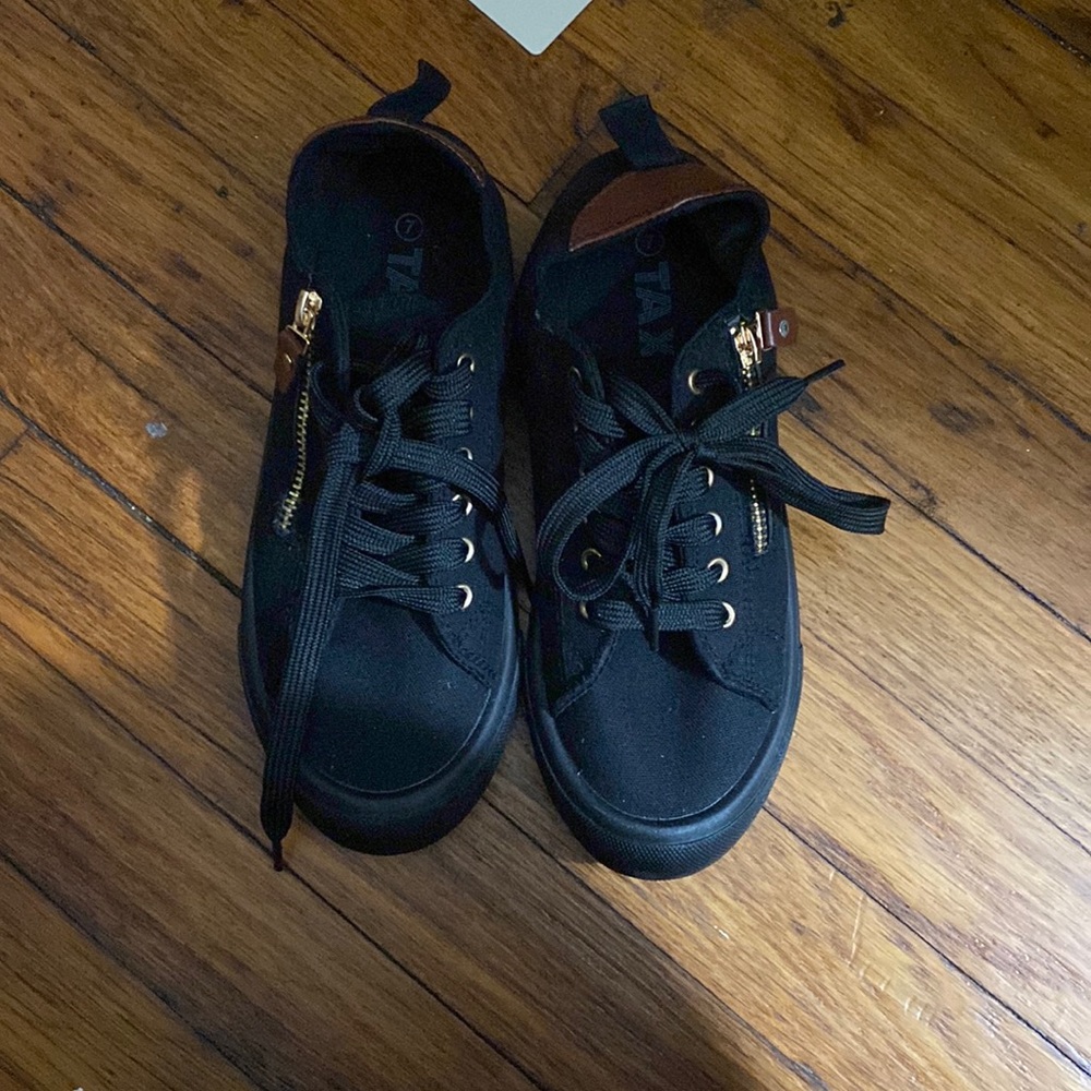Black sneakers with detailed zip up.